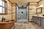 Tiled shower and copper tub in master bath